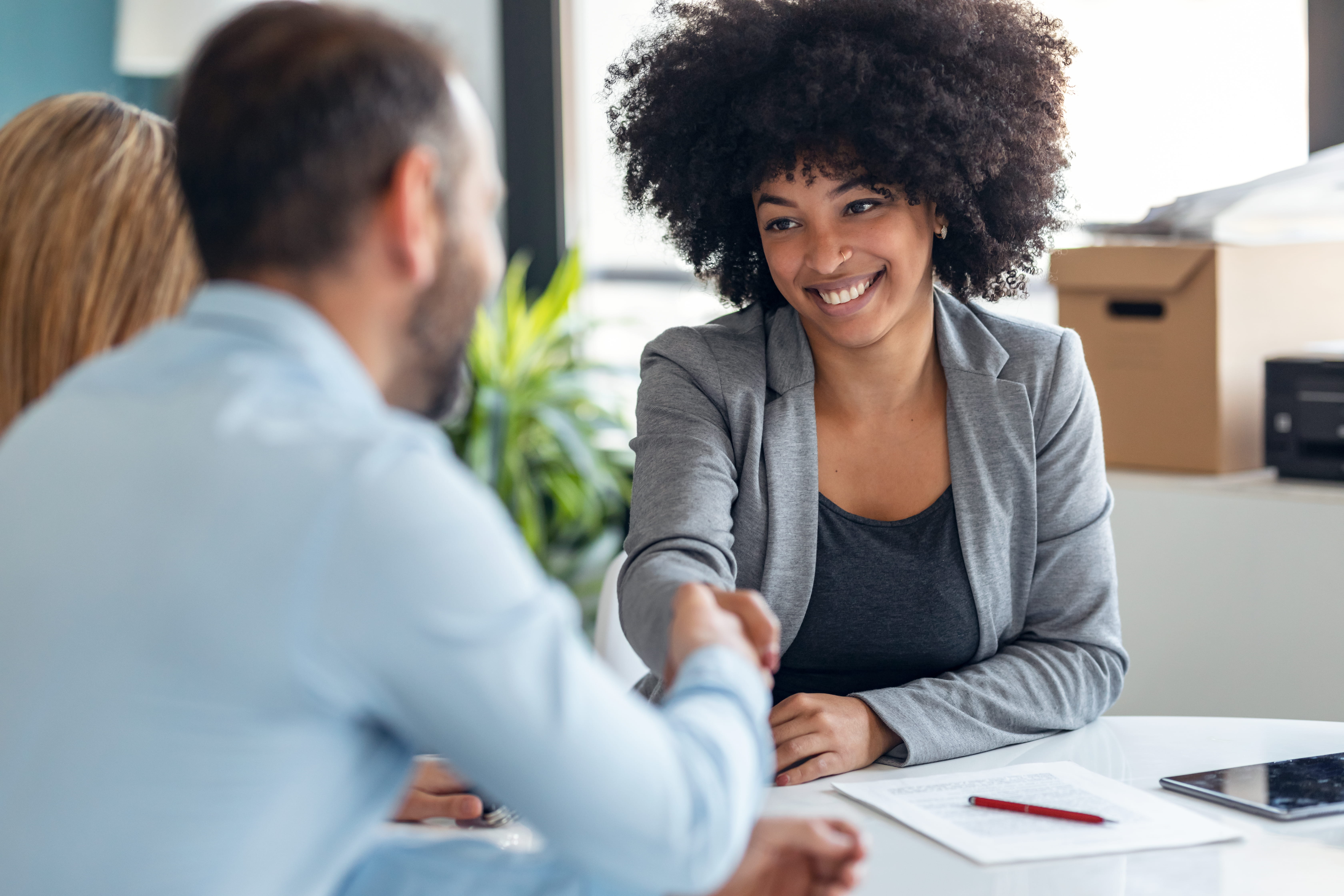 young professional shaking hands with boss